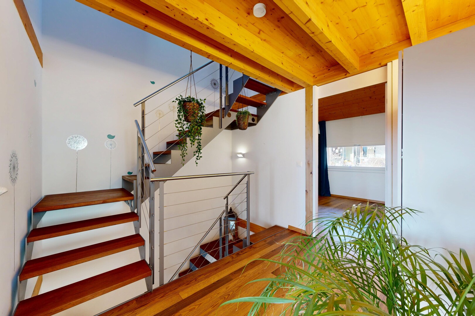 escaliers avec escaliers, inside property, natural light, lumière naturelle, et wood finish floor