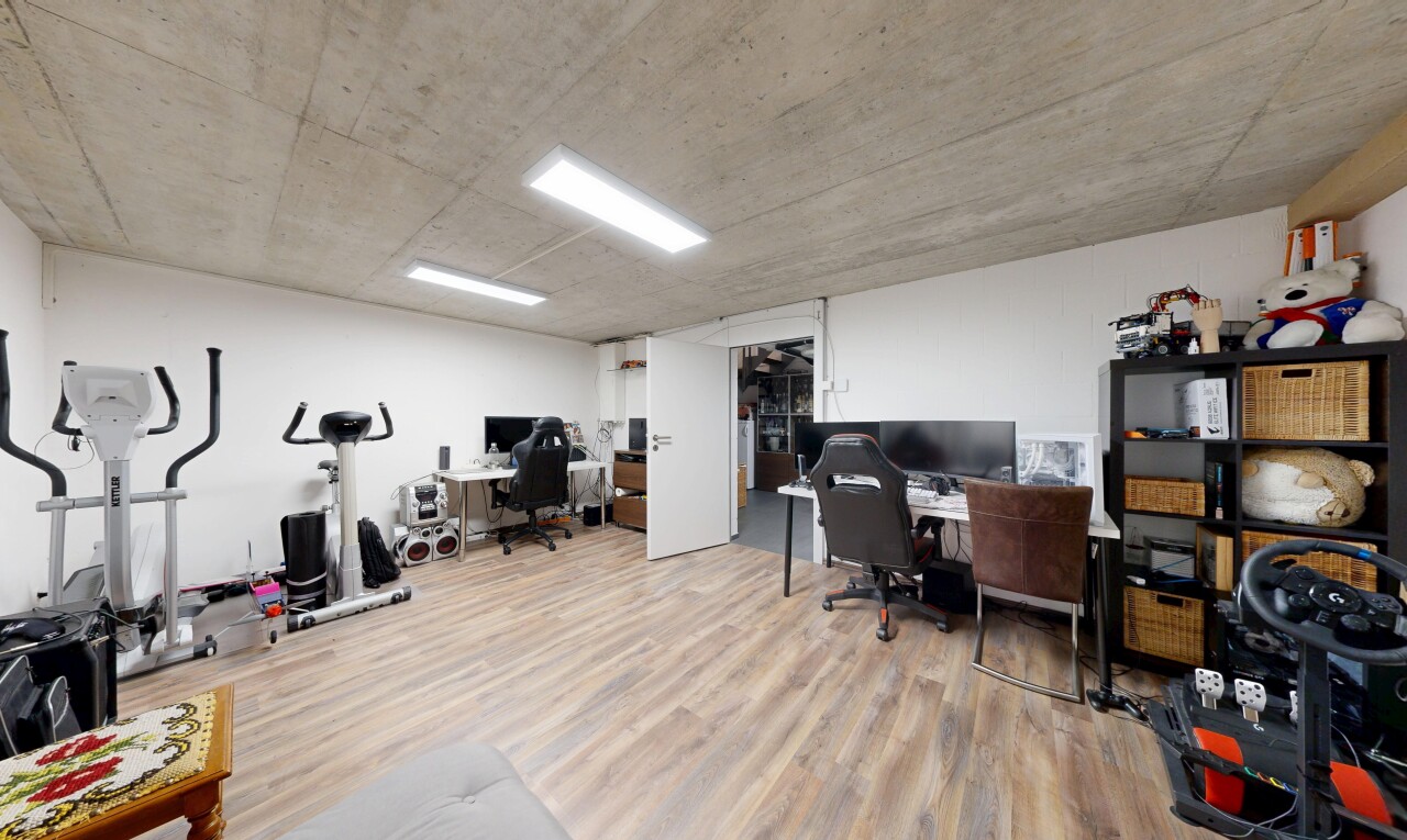 bureau avec espace bureau, inside community, wood finish floor, drywall, et concrete ceiling