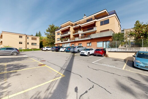 view of apartment building / complex with uncovered parking