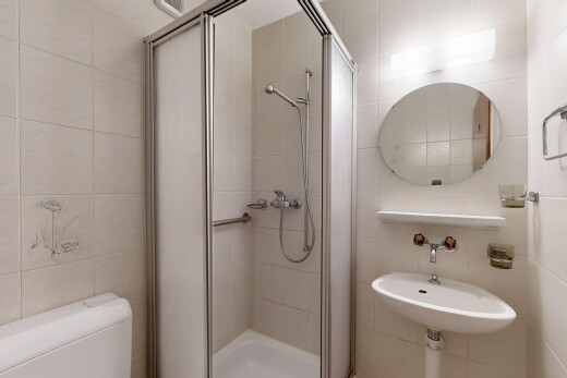 full bath with tile walls and a stall shower