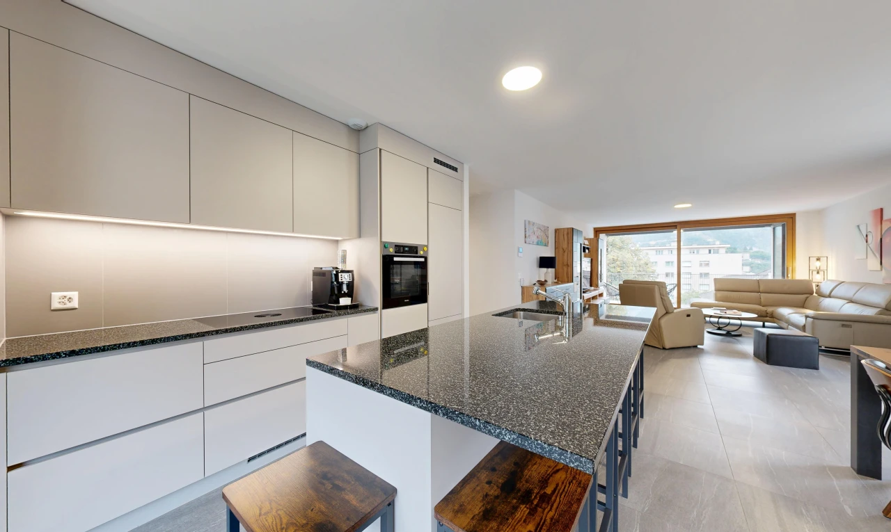 cuisine avec dark countertops, armoires à panneau plat, flat panel cabinets, ouvert sur l'espace de vie, et opens to living area