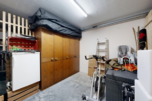 room / bedroom featuring unfinished concrete flooring and washer / dryer