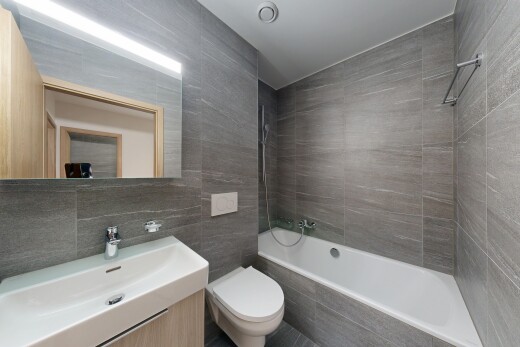 full bathroom featuring tile walls, tiled shower / bath, and vanity
