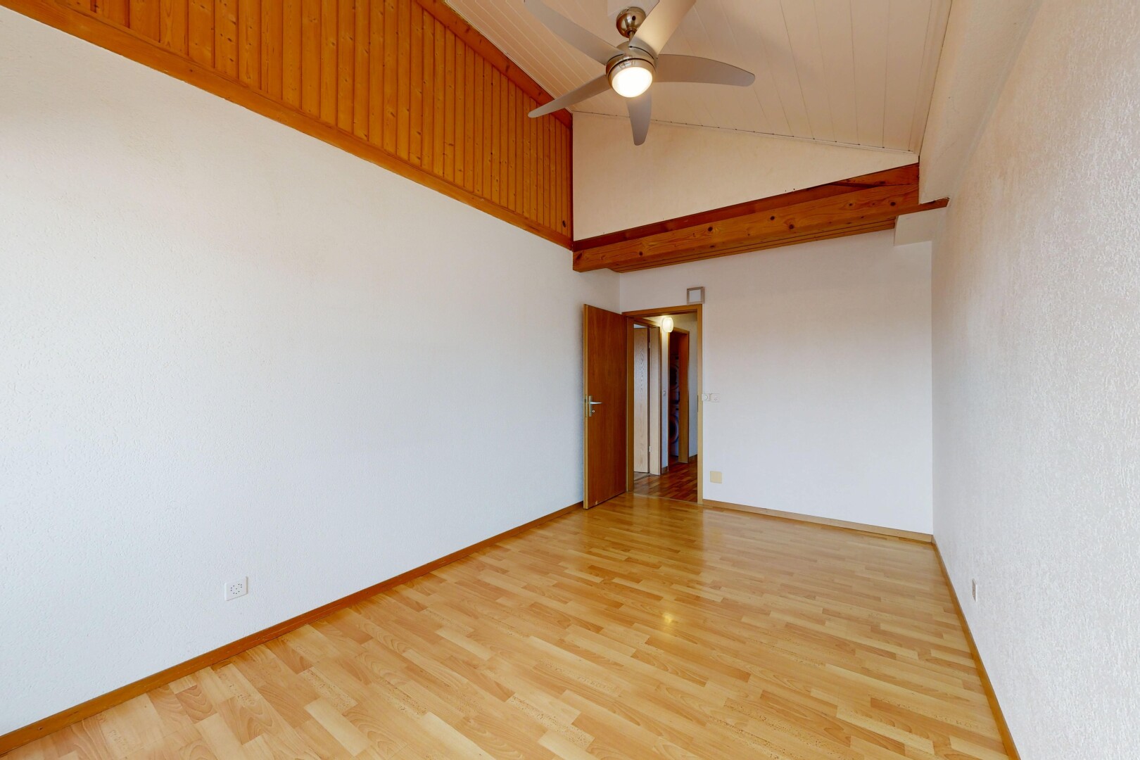 pièce vide avec plafond voûté, vaulted ceiling, sol en finition bois, wood finish floor, et plafond haut