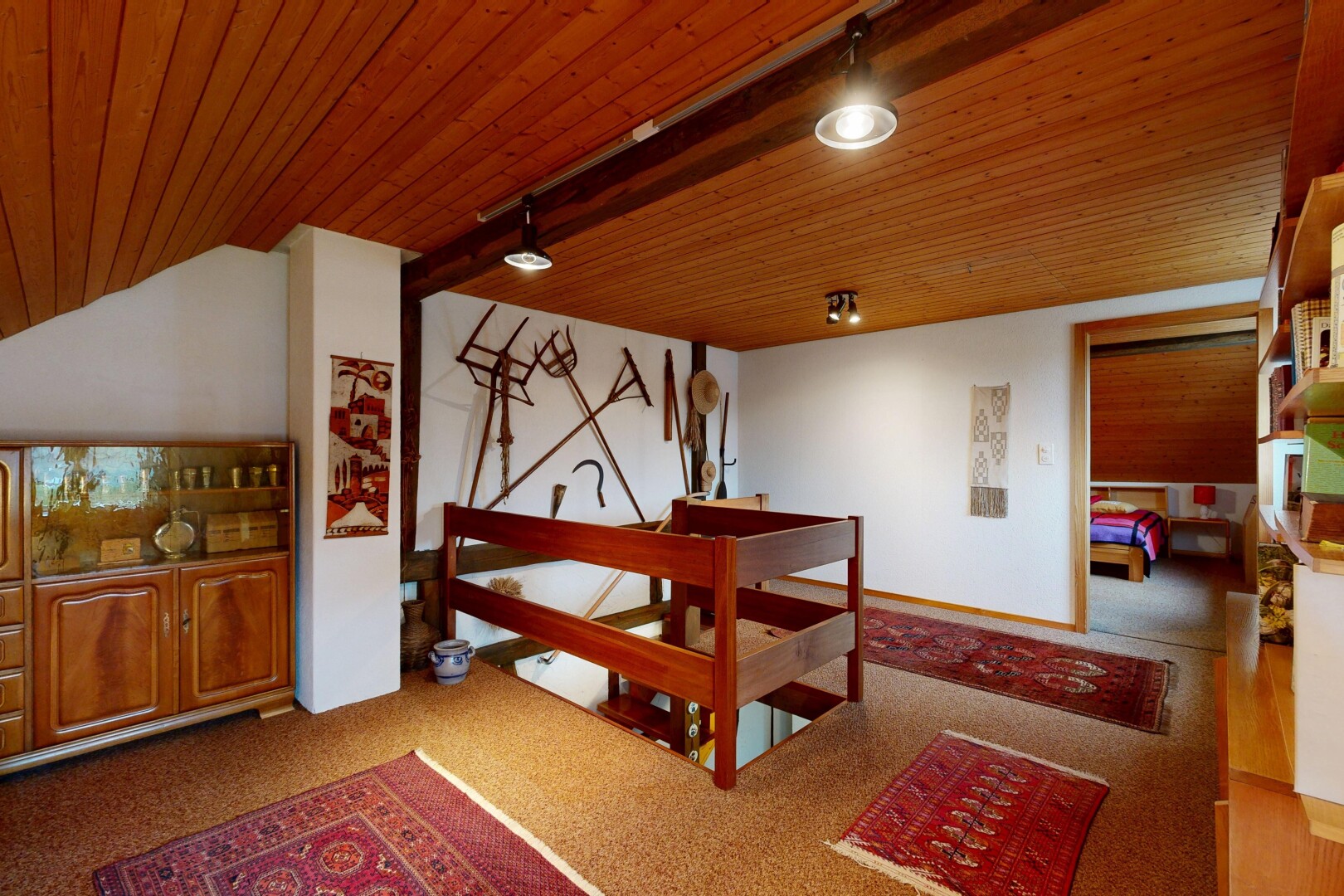 carpeted room with wooden ceiling