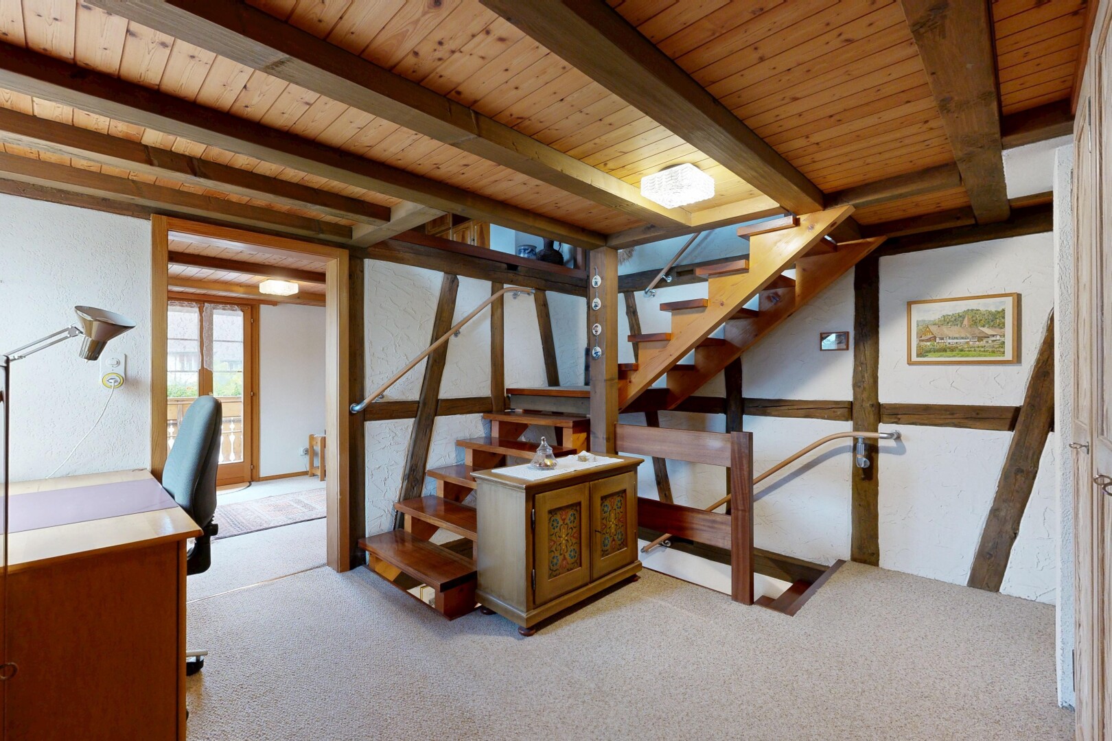 stairway with carpet and beam ceiling