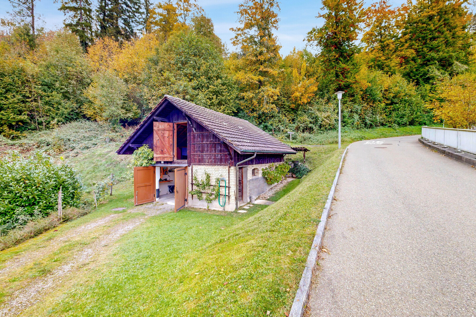 view of home with a lawn and an outbuilding