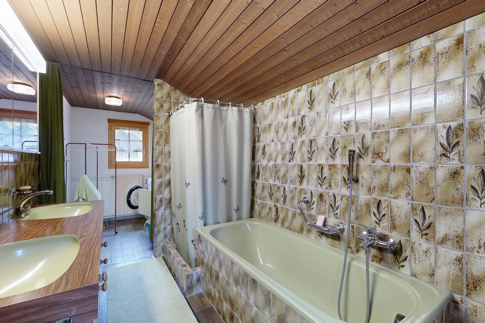 bathroom featuring double vanity, wood ceiling, and tile walls