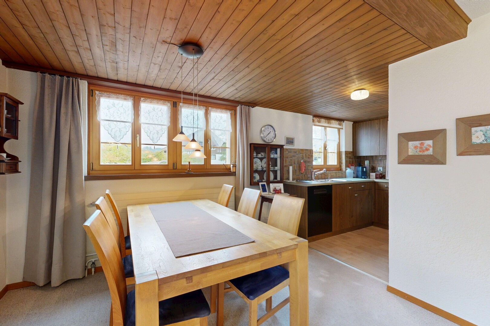 dining room featuring wood ceiling and light carpet