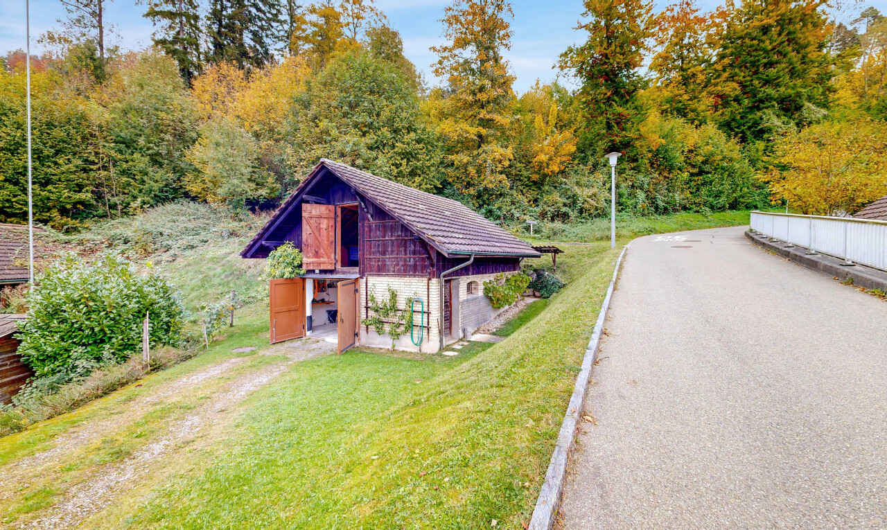 view of home with a lawn and an outbuilding