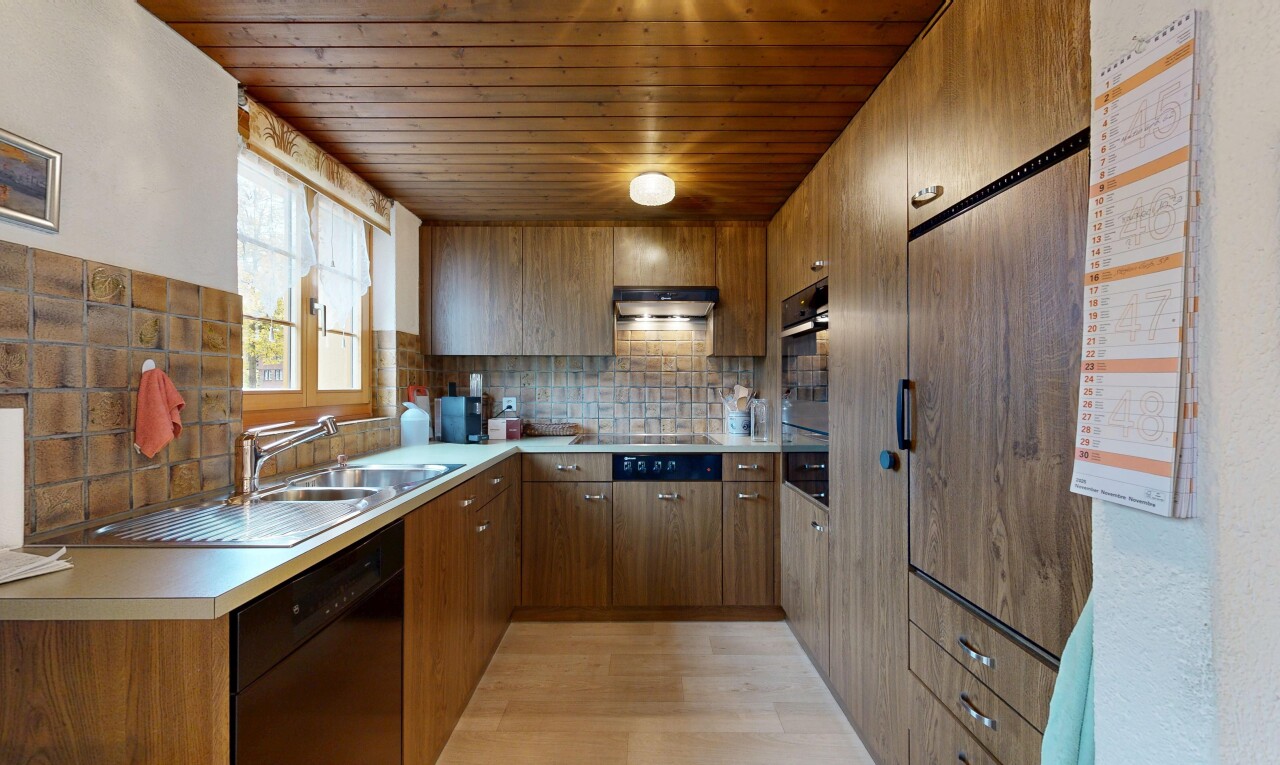 kitchen featuring brown cabinets, black dishwasher, decorative backsplash, light countertops, and wooden ceiling