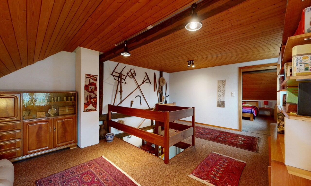 carpeted room with wooden ceiling