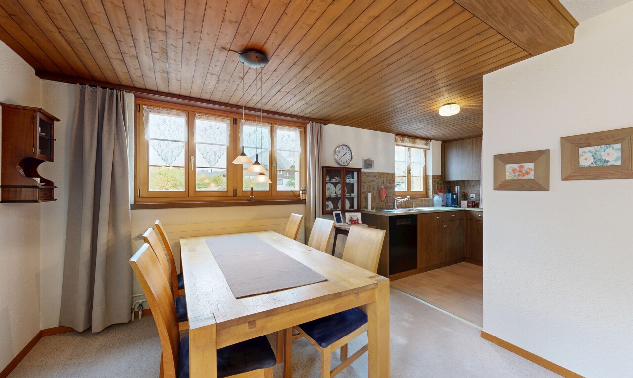 dining room featuring wood ceiling and light carpet