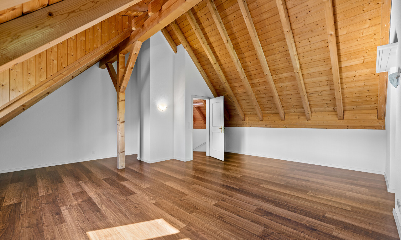 leerer raum mit balkendecke, holzdecke, gipskartonwand, dachschräge, und holzfußboden