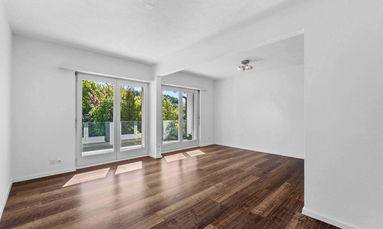 leerer raum mit natürliches licht, sockelleisten, holzfußboden, und gipskartonwand