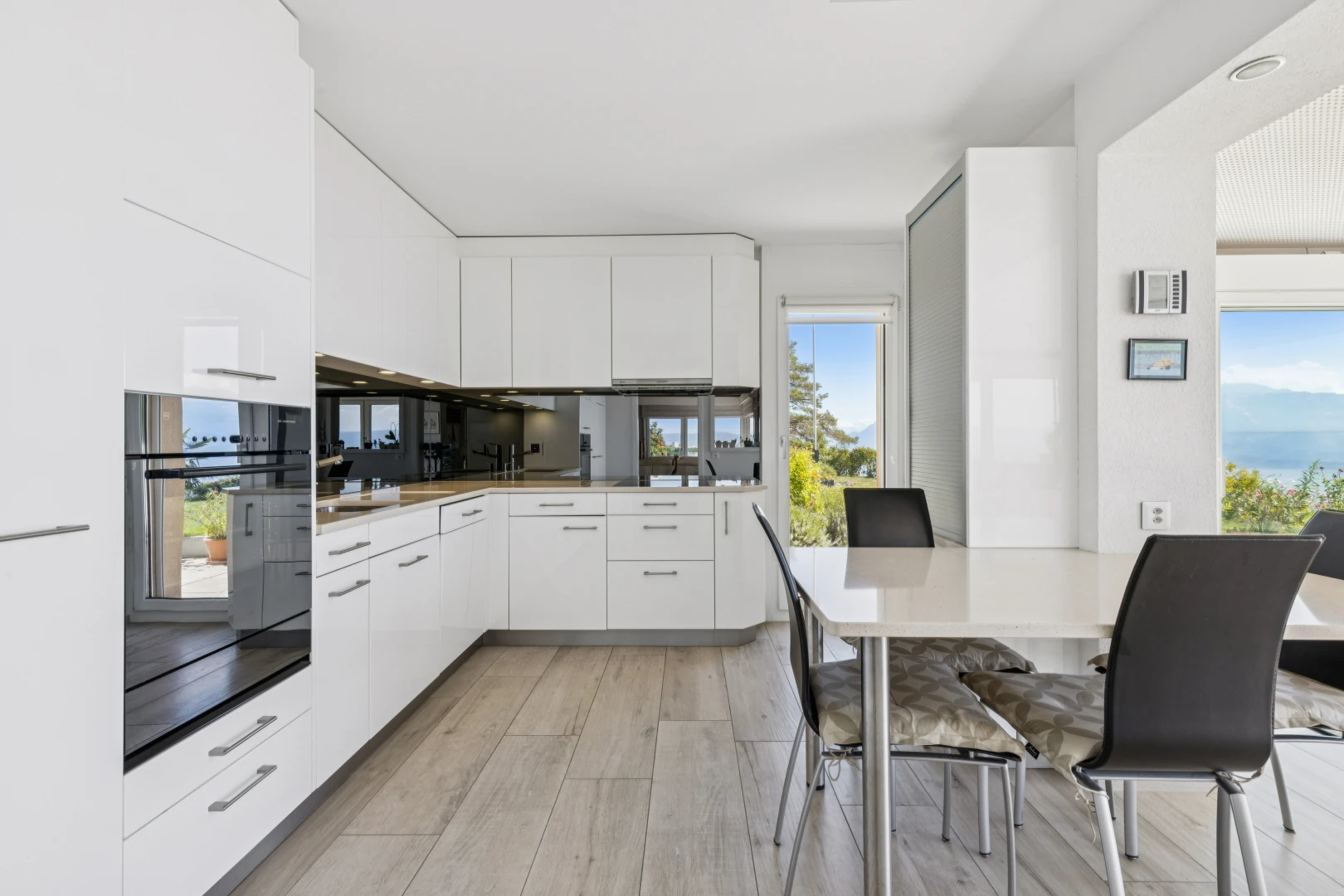 cuisine avec day time, four, light floor, white cabinets, et armoires blanches