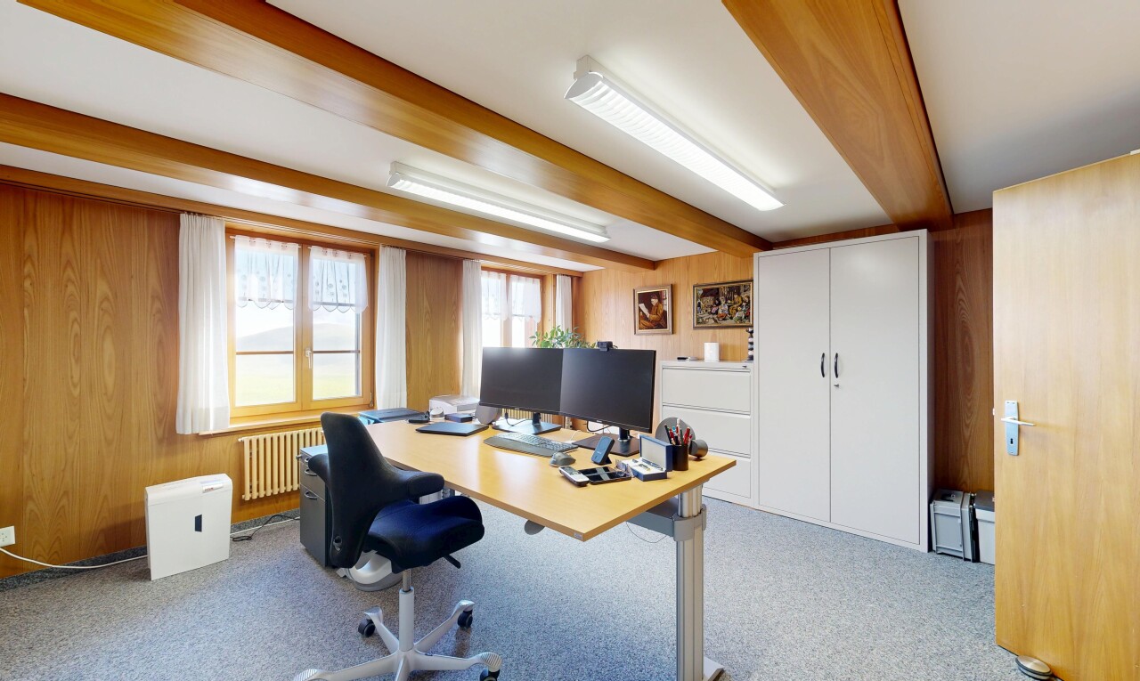 home office with wooden walls, radiator, light colored carpet, and beam ceiling