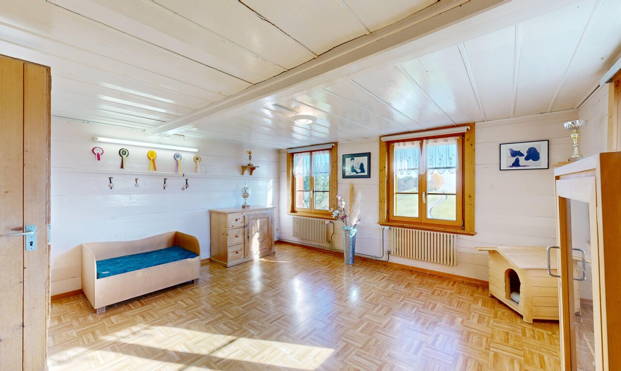 living area with radiator and wooden ceiling