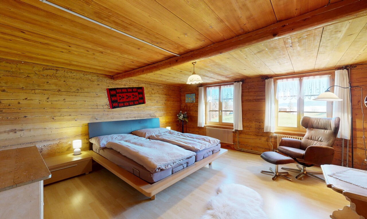 room featuring wood walls, a wood ceiling with exposed beams, radiator heating unit, and wood finished floors