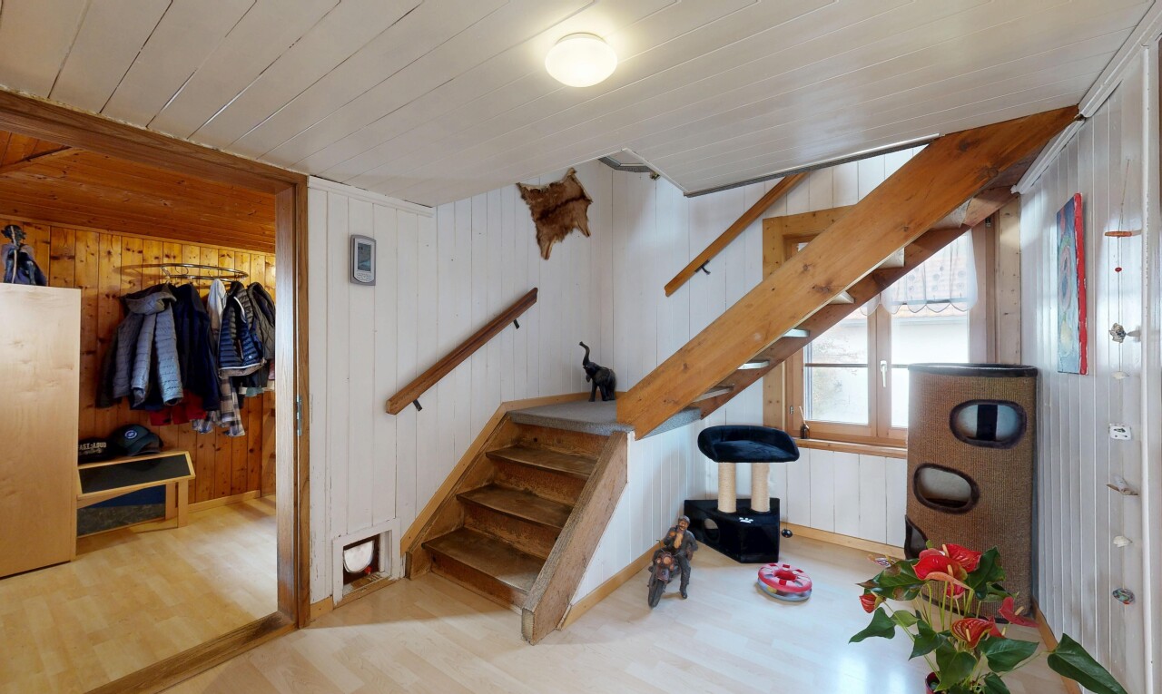 stairway featuring wood walls, wood finished floors, and wood ceiling