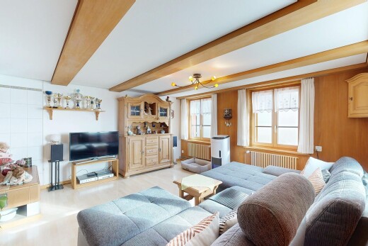 living room with radiator and beam ceiling