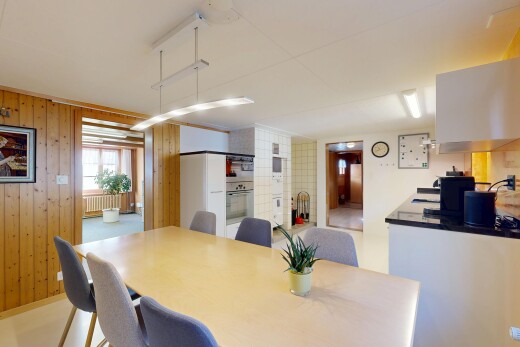 dining space with wooden walls and radiator heating unit
