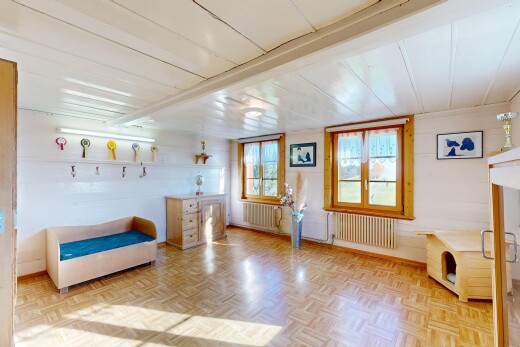 living area with radiator and wooden ceiling
