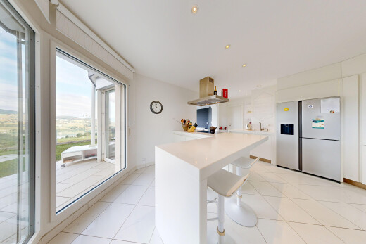kitchen featuring island exhaust hood, freestanding refrigerator, recessed lighting, light countertops, and stainless steel refrigerator with ice dispenser