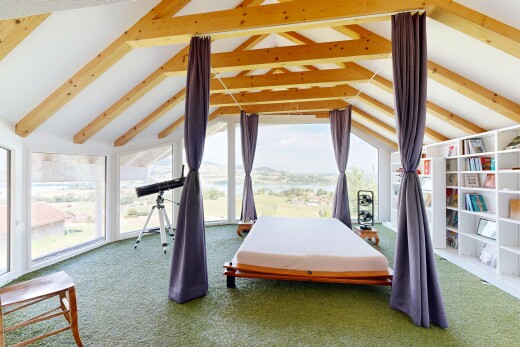 carpeted room with built in features and beamed ceiling