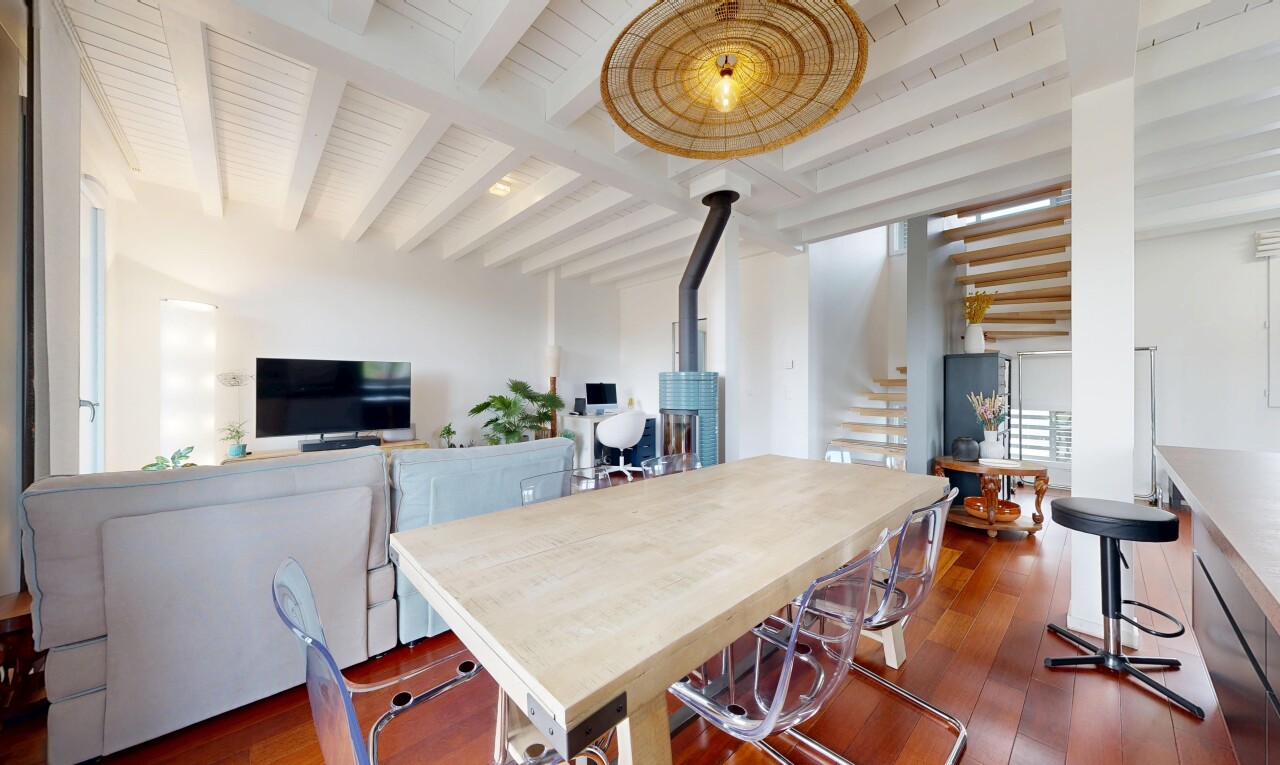 salle à manger avec wood finish floor, sol en finition bois, poêle à bois, télévision, et inside property