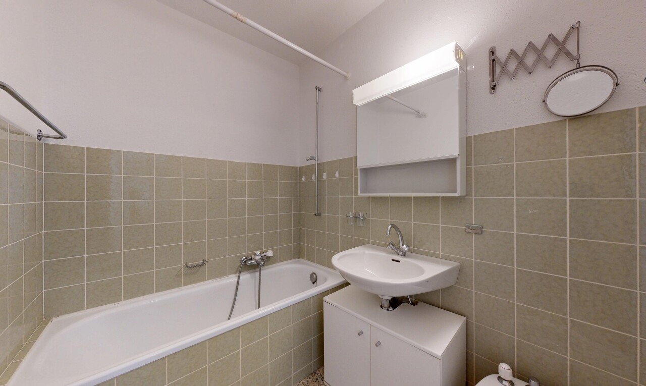 bathroom with tile walls and vanity