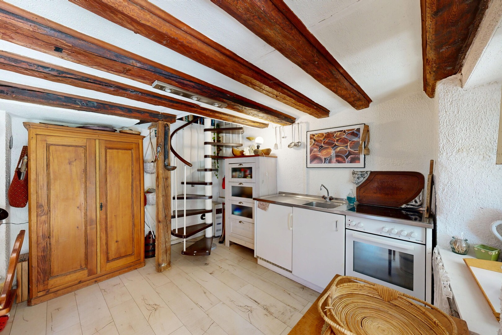 kitchen featuring beamed ceiling, white oven, and light wood-style flooring