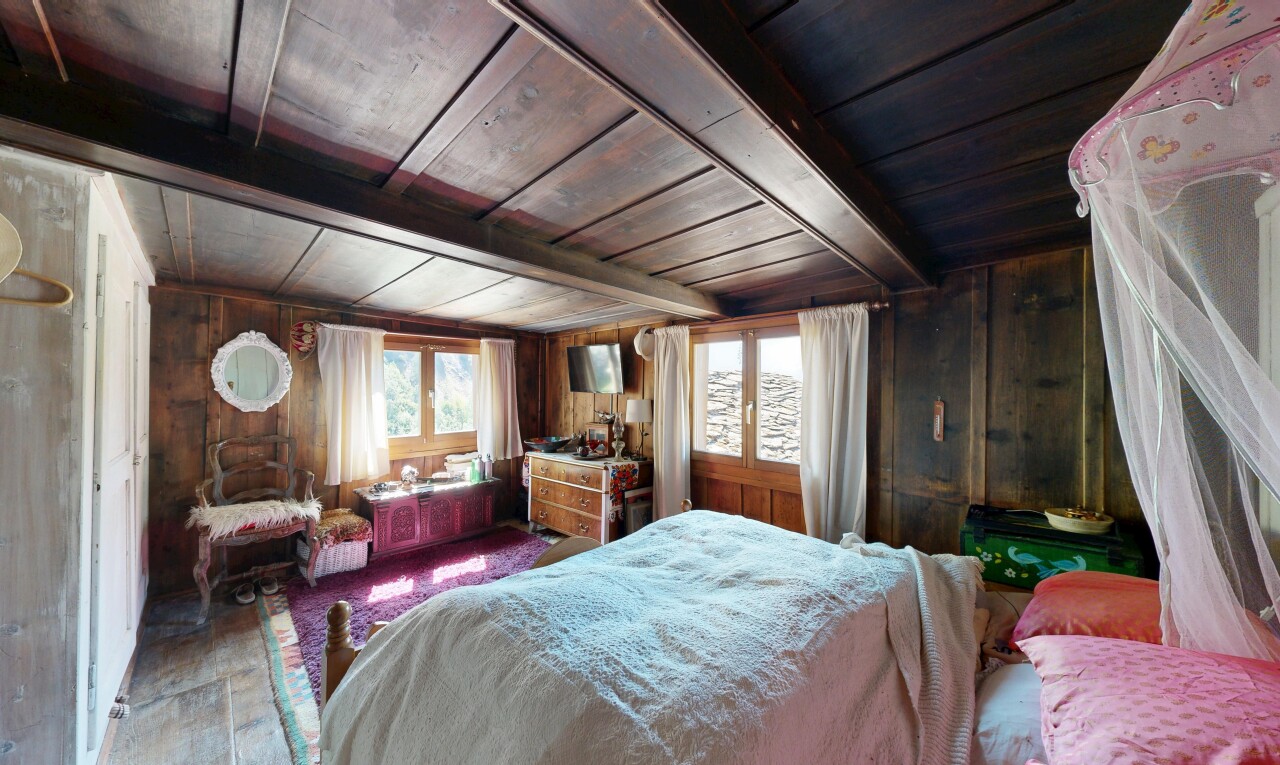 room with a wooden ceiling with exposed beams and wooden walls