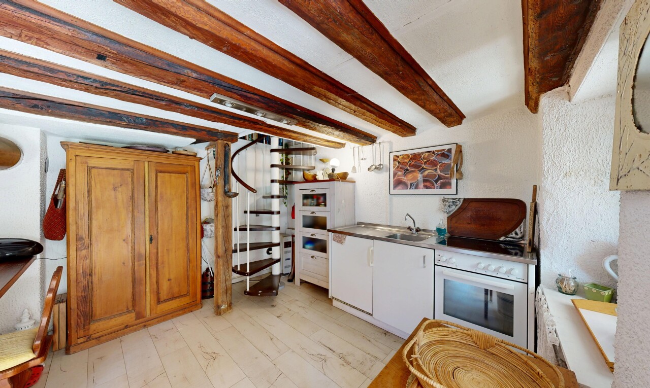 kitchen featuring beamed ceiling, white oven, and light wood-style flooring