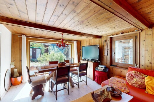dining area featuring a wooden ceiling with exposed beams, wooden walls, and light wood-style floors