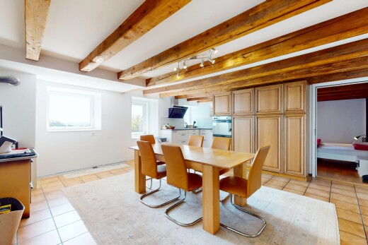 esszimmer mit tile floor, fliesenboden, beamed ceiling, balkendecke, und natural light