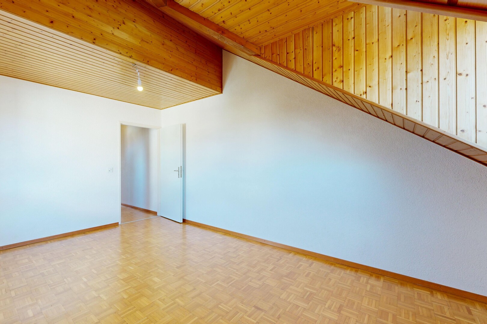spare room with parquet floors and baseboards