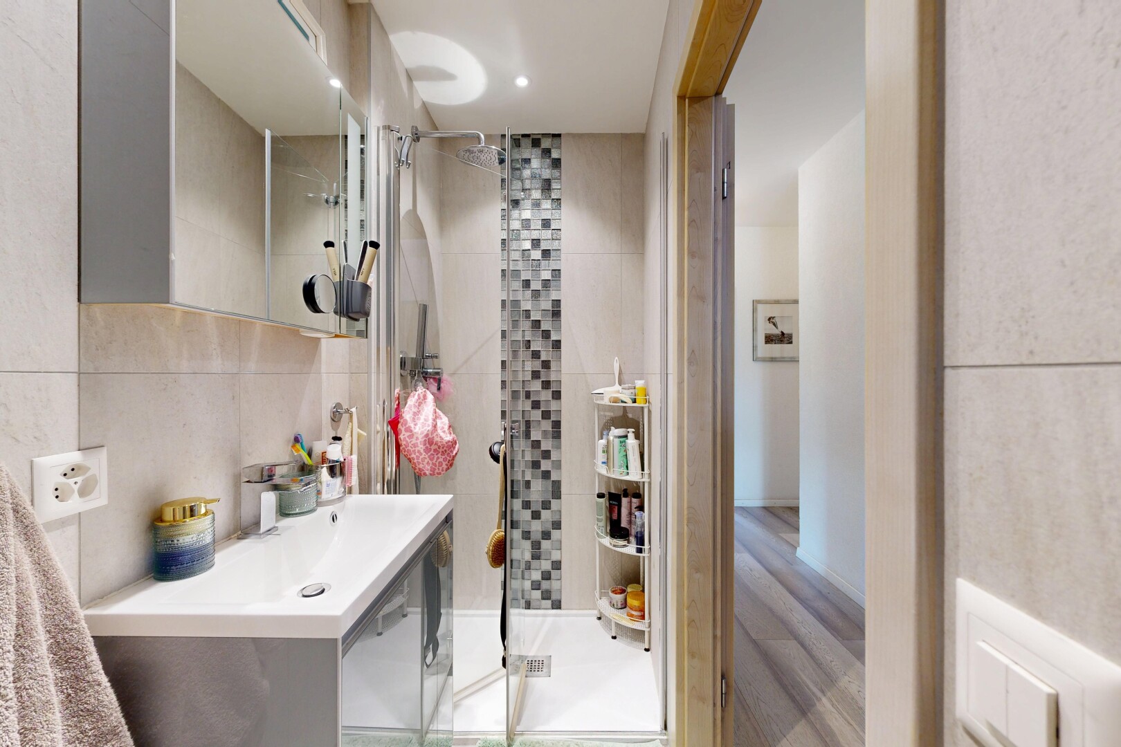 full bath featuring a shower stall and tile walls