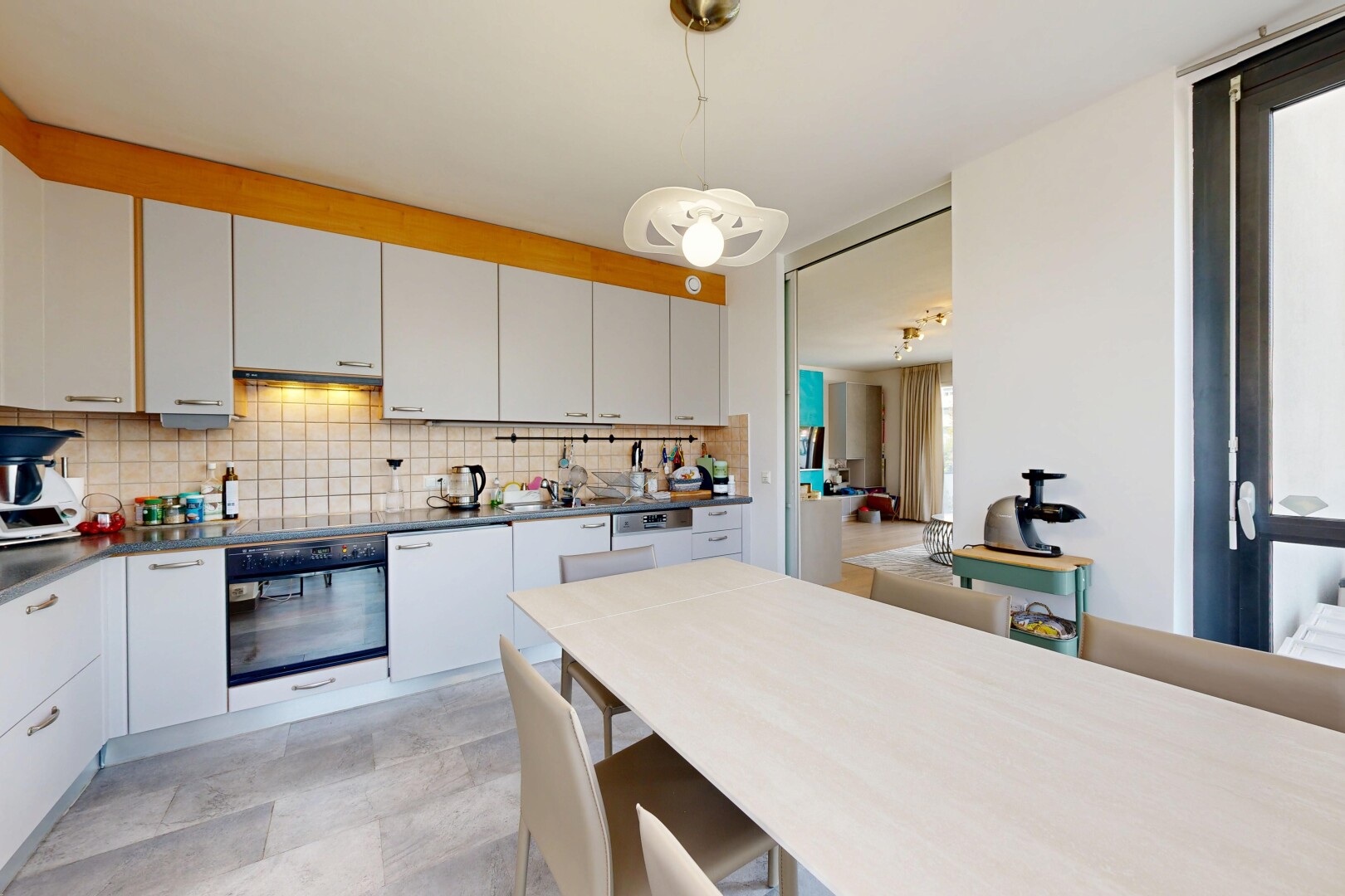 kitchen with wall oven, white cabinets, tasteful backsplash, hanging light fixtures, and dark countertops