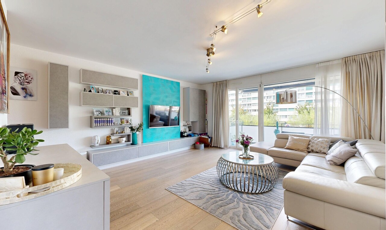 living area with light wood-style flooring and track lighting