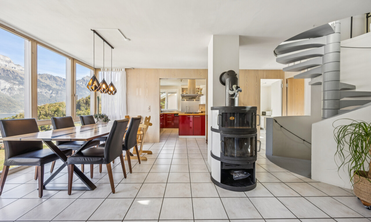 dining room with a mountain view, light tile patterned floors, and expansive windows