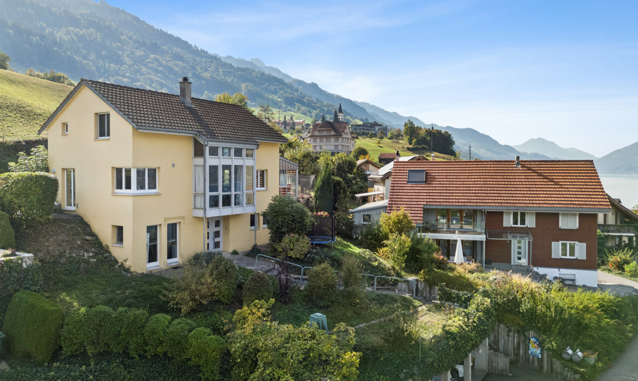 view of home featuring a mountain view, a chimney, a tile roof, and stucco siding