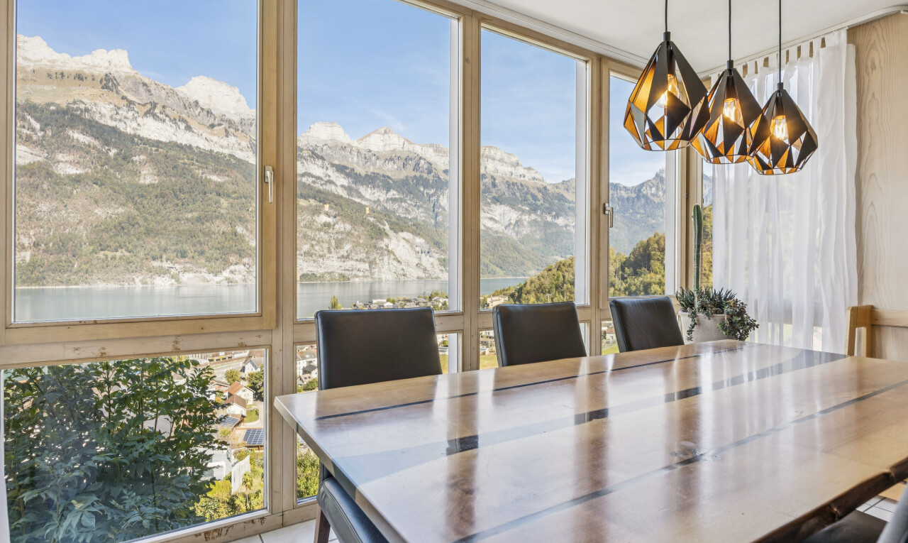dining area with a mountain view, expansive windows, and light tile patterned flooring