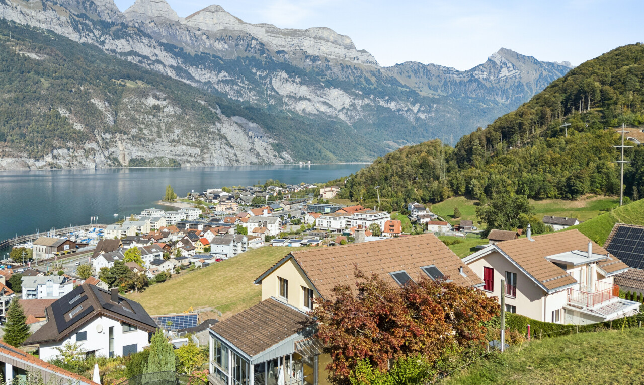 view of mountain backdrop with nearby suburban area and a large body of water