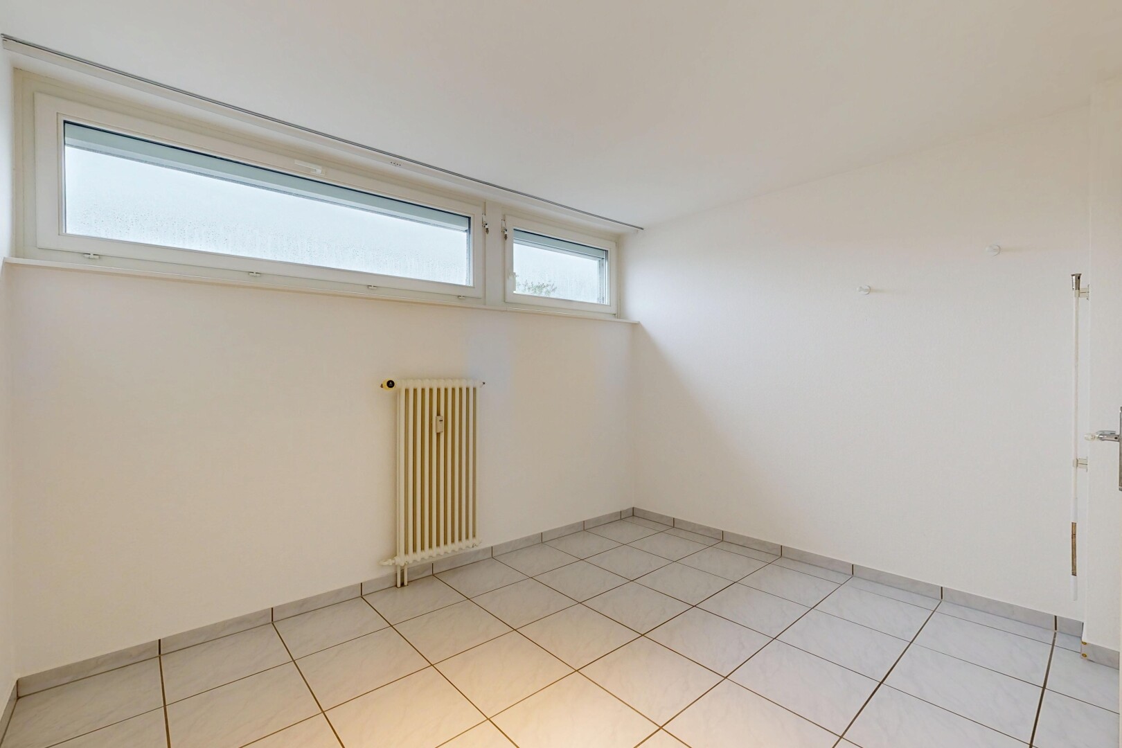 empty room featuring radiator heating unit and baseboards