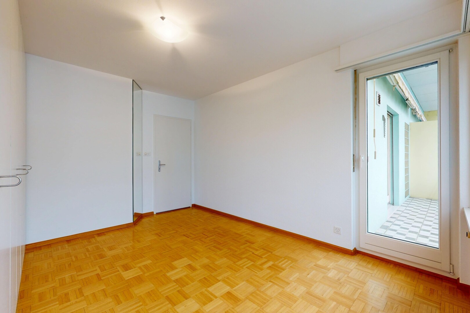 spare room featuring parquet floors and baseboards