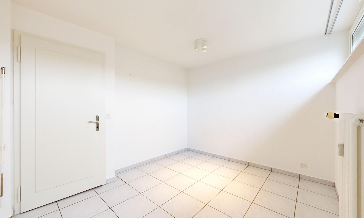 spare room featuring baseboards and light tile patterned flooring