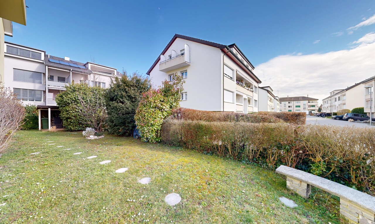view of property with a lawn and stucco siding