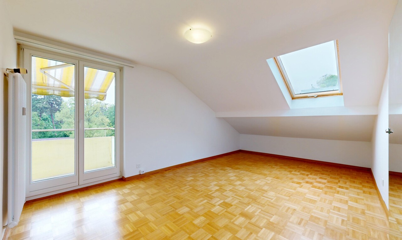 spare room featuring parquet floors, a skylight, and lofted ceiling