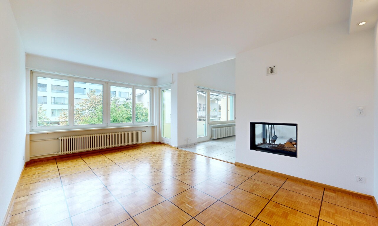 empty room with radiator heating unit, a multi sided fireplace, and radiator